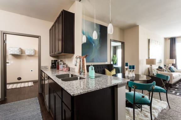 an open floor plan with an espresso kitchen and living room at The Avenue at Polaris Apartments, Columbus, Ohio