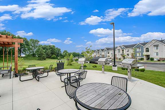 Grilling stations with seating at The Crossings Apartments in Kentwood, MI
