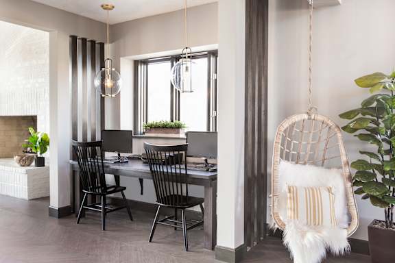 two work stations with chairs and computer monitors with decorations at Evansville Apartments