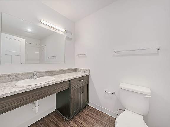 A bathroom with a sink and mirror at Trade Winds Apartment Homes, Elkhorn, NE