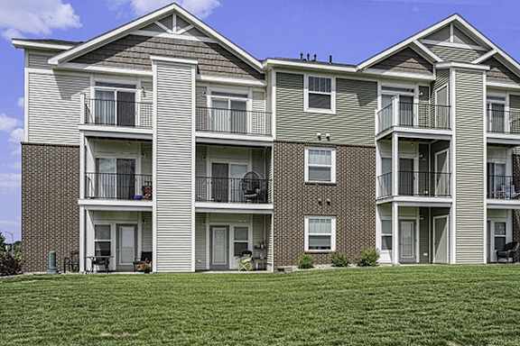 Apartment building with balconies and patios at Trade Winds Apartment Homes in Elkhorn, NE