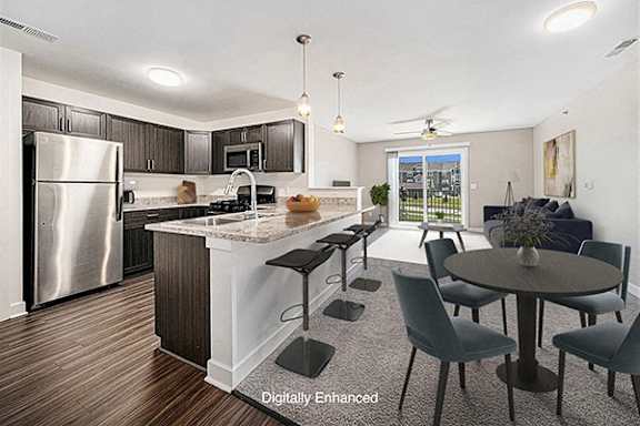 A modern kitchen with a breakfast bar and dining table and chairs at Trade Winds Apartment Homes, Elkhorn, NE