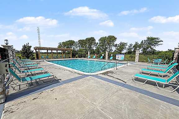 Swimming Pool with Large Sundeck at Trade Winds Apartment Homes in Elkhorn, NE