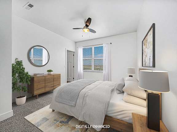 large bedroom with a ceiling fan and a window at Trade Winds Apartment Homes, Elkhorn, Nebraska