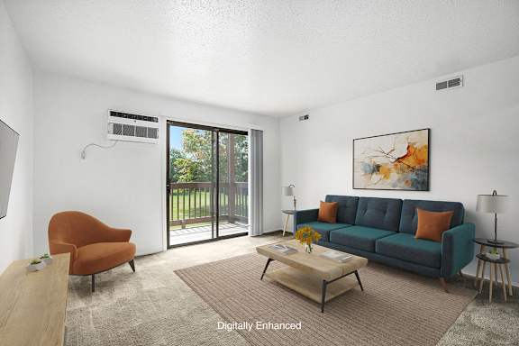A living room with a blue couch, a brown chair, and a painting on the wall at Trappers Cove Apartments, Michigan, 48910