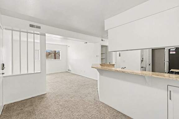 A dining room with a breakfast bar at Trappers Cove Apartments, Lansing