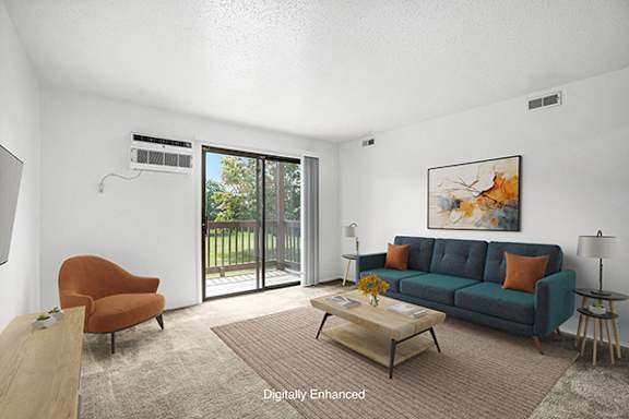 A living room with a couch, a chair, a coffee table, and a slider to a private balcony at Trappers Cove Apartments in Lansing, MI