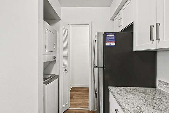 A kitchen with a washer and dryer at Trappers Cove Apartments, Lansing, 48910