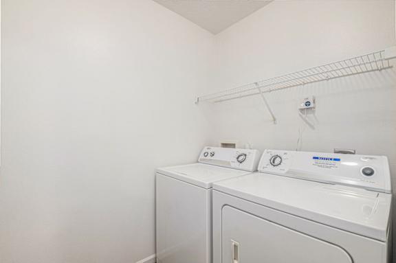 A laundry room with a full size washer and dryer at Trillium Pointe Apartment Homes, Michigan, 49201