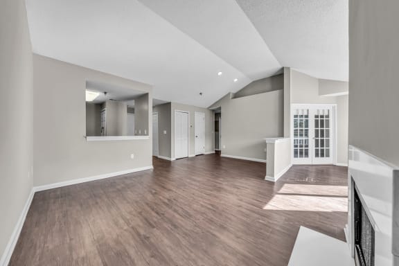 the living room and dining room of a new home with hardwood flooring at Trophy Club at Bellgrade, Midlothian, VA, 23113