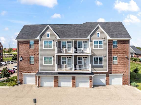 A large two-story house with a garage on the ground floor.