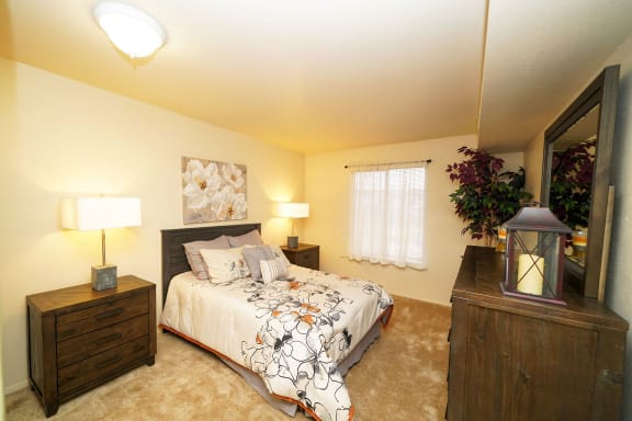a bedroom with a bed and a window at Walnut Trail Apartments, Portage