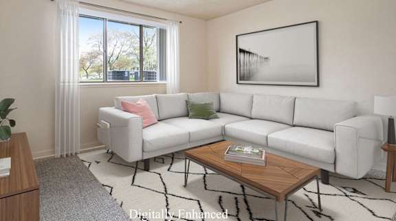 A living room with a grey couch, a wooden coffee table, and a large window with curtains at Walnut Trail Apartments, Portage, MI, 49002