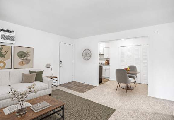 Living room and dining area with modern furnishings at Walnut Trail Apartments, Portage, MI