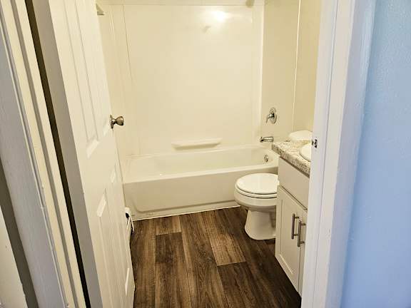 A bathroom with a toilet, sink, and bathtub A bathroom with a toilet, sink, and bathtub at Waverly Park Apartments, Lansing