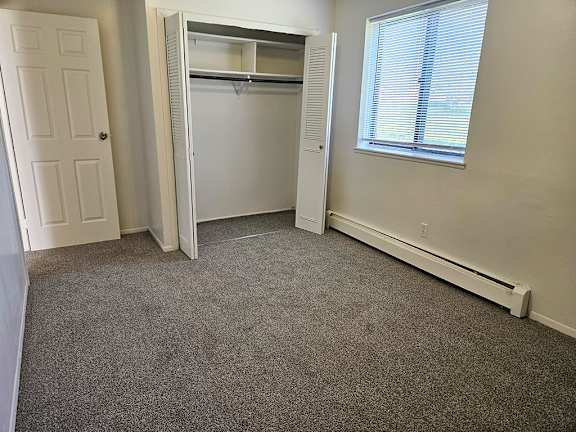 A bedroom with a closet and a window A bedroom with a closet and a window at Waverly Park Apartments, Lansing