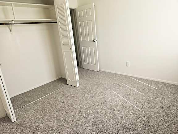 A bedroom with a closet with shelves A bedroom with a closet with shelves at Waverly Park Apartments, Lansing