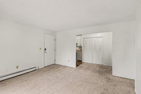 A dining room with a carpeted floor at Waverly Park Apartments, Lansing, Michigan