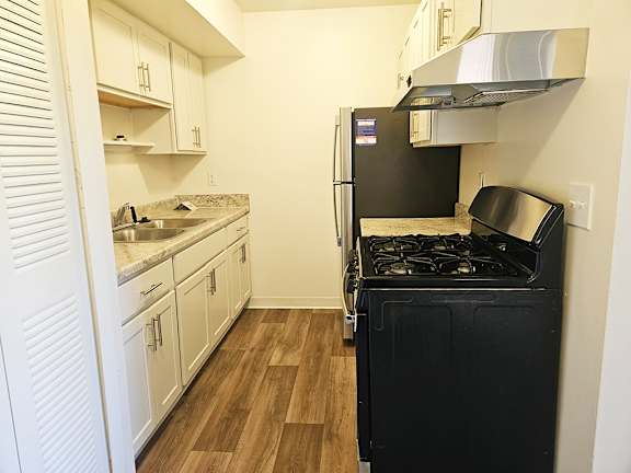 A kitchen with stainless steel appliances and white shaker style cabinets A kitchen with stainless steel appliances and white shaker style cabinets at Waverly Park Apartments, Lansing