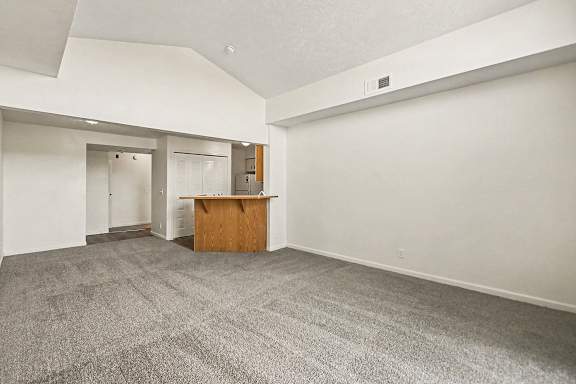 A dining room with a carpeted floor and a breakfast bar at West Hampton Park Apartment Homes, Nebraska, 68022