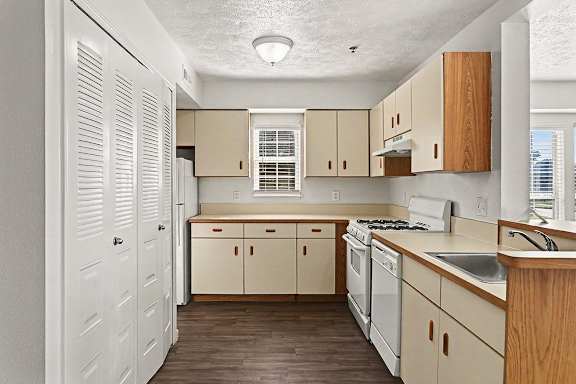 A kitchen with wooden cabinets and a window at West Hampton Park Apartment Homes, Nebraska, 68022