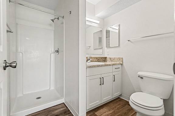 An ensuite bathroom with a toilet, sink, and shower at West Hampton Park Apartment Homes, Nebraska, 68022