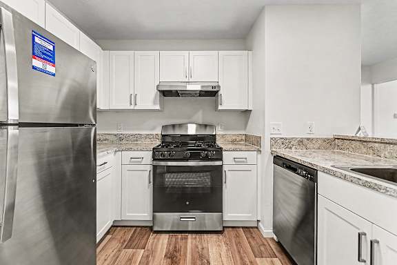 A kitchen with a stainless steel refrigerator, oven and dishwasher at West Hampton Park Apartment Homes, Nebraska, 68022