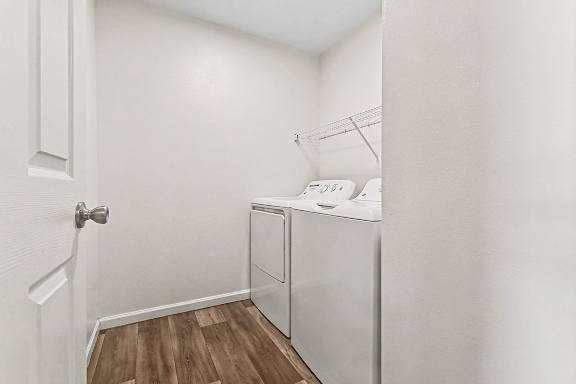 A small laundry room with a washer and dryer at West Hampton Park Apartment Homes, Nebraska, 68022