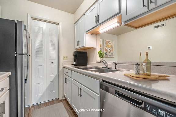 An upgraded kitchen with pantry at West Wind Apartments in Fort Wayne, IN