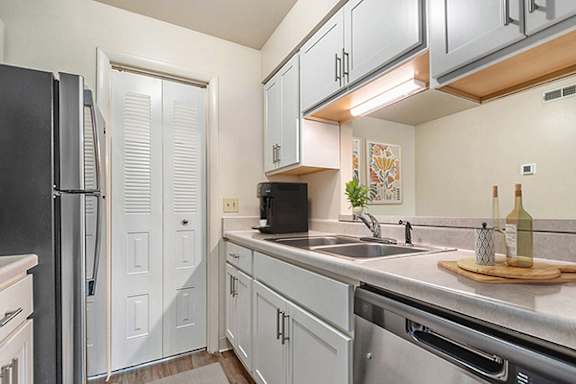 Galley Kitchen with Gas Range at West Wind Apartments in Fort Wayne, IN