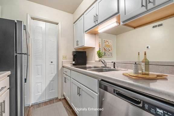 A kitchen with white cabinets and stainless steel appliances A kitchen with white cabinets and stainless steel appliances at West Wind Apartments, Indiana, 46808
