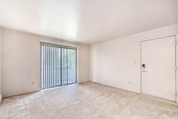 spacious living room with plush carpeting at West Wind Apartments, Fort Wayne, Indiana