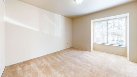 bedroom with a large window at Windmill Lakes Apartments, Holland, 49424
