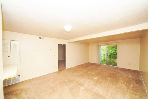 living room and dining room with plush carpeting at Windmill Lakes Apartments, Holland, 49424