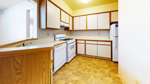 a kitchen with white appliances at Windmill Lakes Apartments, Holland, 49424