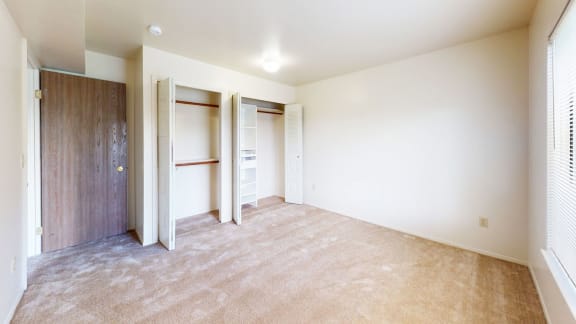 bedroom with doors to a large closet with organizers at Windmill Lakes Apartments, Holland, 49424