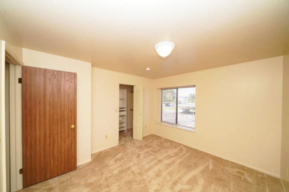 second bedroom with a walk-in closet at Windmill Lakes Apartments, Holland, 49424