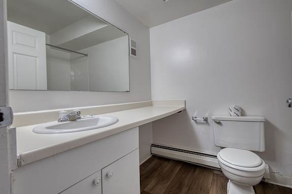 A white bathroom with large vanity at Wood Creek Apartments, Kenosha, WI, 53144