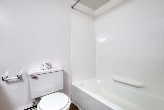 A bathroom with a bathtub and toilet at Wood Creek Apartments, Kenosha
