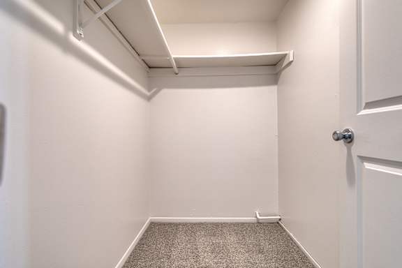 A large walk-in closet at Wood Creek Apartments, Kenosha