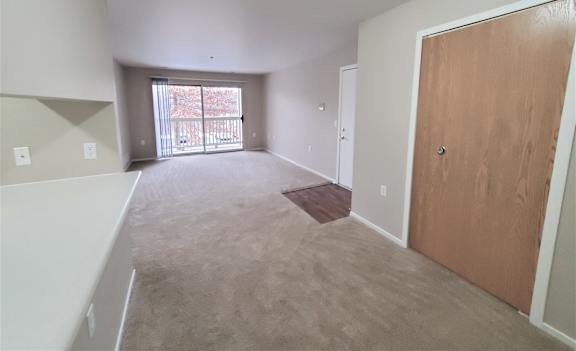 The living room and dining room with a walk-in closet.