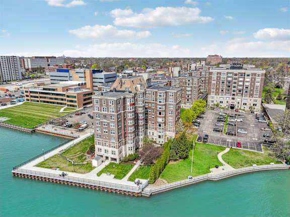 A large building sits on a pier over water.