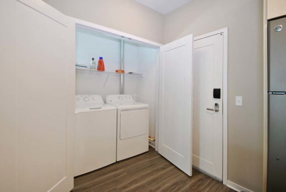 a laundry room with a washer and dryer at The George, Ann Arbor, MI