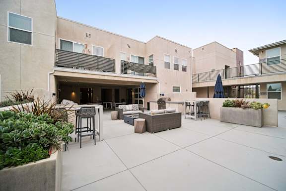 A patio area with a table and chairs.