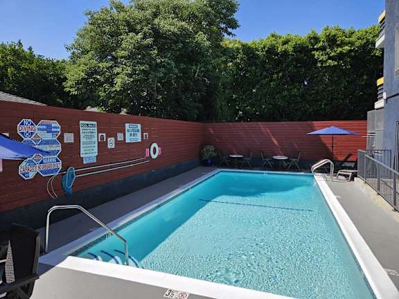 a swimming pool in a backyard with a fence