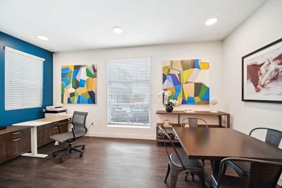 A conference room with a long table and chairs.