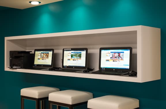 Business center with computers and workstations at Oasis at Lake Encino Apartments, California