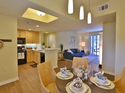 Open dining area with living room and kitchen at Oasis at Lake Encino Apartments, California, 91316