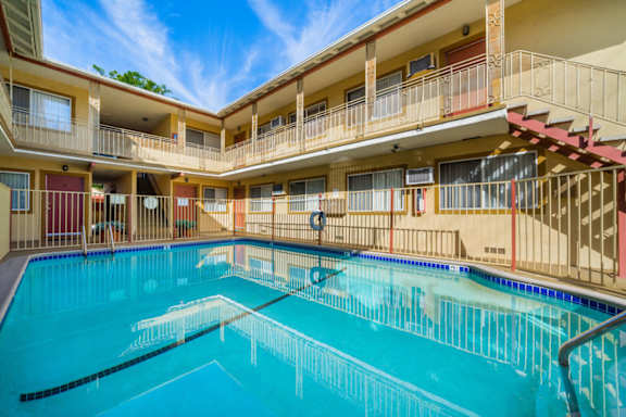 A large indoor swimming pool with a diving board.
