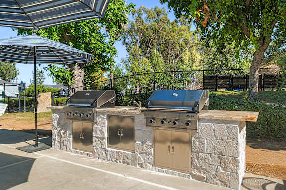 A stone wall with two grills on top.